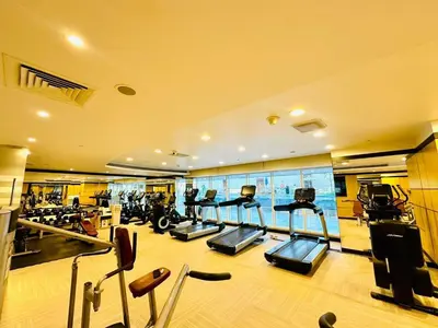 a gym with several treadmills and exercise bikes at 5 Star Hotel Residence Apartment- Walking to Downtown Dubai Mall in Dubai