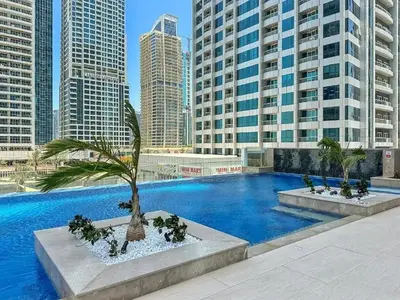 a large swimming pool in a city with tall buildings at Stonetree - Brand New Studio - Prime Location in Dubai