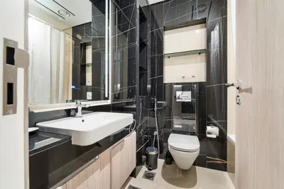 a bathroom with a white sink and a toilet at Stonetree - Brand New Studio - Prime Location in Dubai