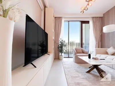 a living room with a large tv on a wall at Amazing stay at Dubai creek with Balcony & View in Dubai