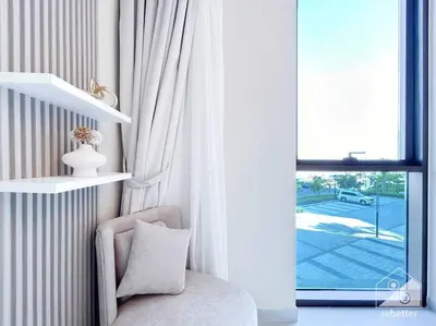 a living room with a chair and a window at Amazing stay at Dubai creek with Balcony & View in Dubai
