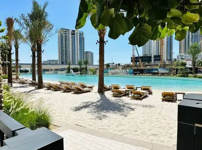 a beach with lounge chairs and a swimming pool at Amazing stay at Dubai creek with Balcony & View in Dubai