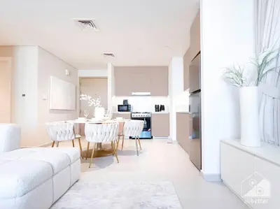 a white living room with a table and chairs at Amazing stay at Dubai creek with Balcony & View in Dubai