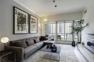 a living room with a couch and a table at Dubai Marina Walking distance to metro Marina View in Dubai