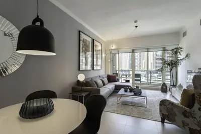 a living room with a couch and a table at Dubai Marina Walking distance to metro Marina View in Dubai