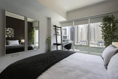 a bedroom with a large bed and a large window at Dubai Marina Walking distance to metro Marina View in Dubai