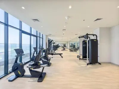 a gym with treadmills and cardio equipment in a building at Silkhaus Luxurious Studio in High End Neighborhood in Dubai