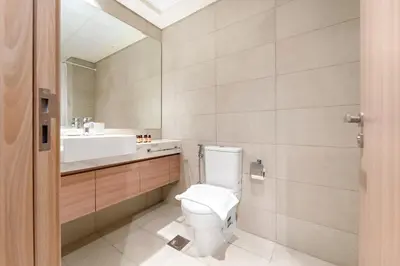 a bathroom with a toilet and a sink at Silkhaus Luxurious Studio in High End Neighborhood in Dubai
