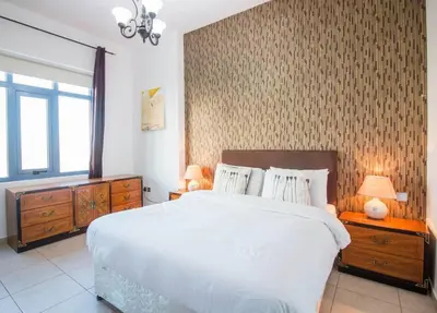 a bedroom with a large white bed and a window at Ideal for Families Close to ALL Amenities in Dubai