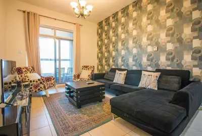 a living room with a couch and a table at Ideal for Families Close to ALL Amenities in Dubai