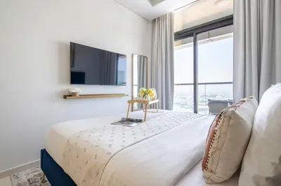 a bedroom with a large bed with a large window at Frank Porter - Aykon City Tower in Dubai