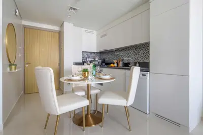 a kitchen with a table and chairs in a room at Frank Porter - Aykon City Tower in Dubai
