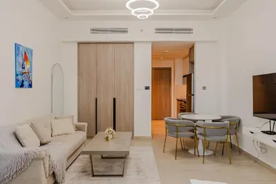 a living room with a couch and a table at Cozy Studio in JLT I Medore in Dubai