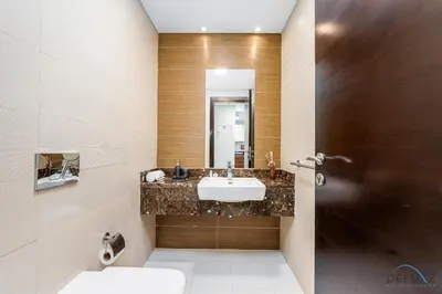 a bathroom with a sink and a mirror at Charming 1BR Apartment in Sparkle Tower 1, Dubai Marina by Deluxe Holiday Homes in Dubai