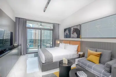 a hotel room with a bed and a couch at City Retreat MAG 318,Downtown Dubai 5 minutes walk to Dubai mall in Dubai
