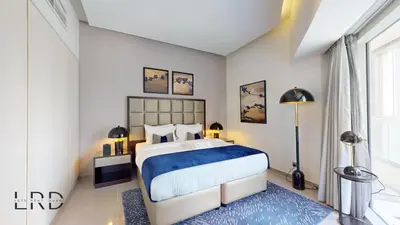 a bedroom with a large bed and a blue rug at Luxury Studio in Business Bay in Dubai