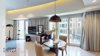 a living room with a table and chairs and a dining room at Luxury Studio in Business Bay in Dubai