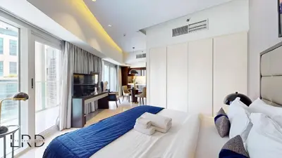a bedroom with a large bed and a large window at Luxury Studio in Business Bay in Dubai