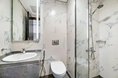a bathroom with a toilet and a sink at Chic Urban Escape at Studio MAG 422 in Dubai