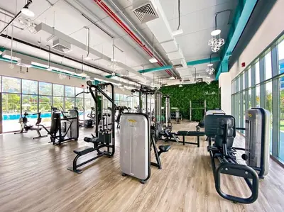 a gym with treadmills and exercise equipment in a building at Chic Urban Escape at Studio MAG 422 in Dubai