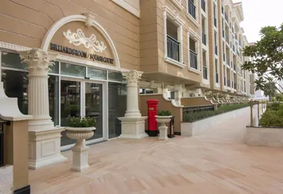a shopping mall with a red door and a building at Furnished Studio Ready to Move-in in Dubai
