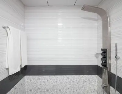 a white bathroom with a shower and a toilet at Furnished Studio Ready to Move-in in Dubai