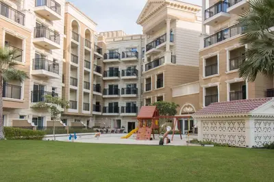 a playground in front of a large apartment building at Furnished Studio Ready to Move-in in Dubai