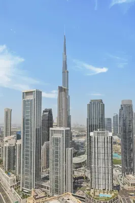 a view of a city skyline with a tall skyscraper at Luxury Stay with Burj Khalifa Views & Infinity Pool in Dubai