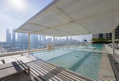 a swimming pool on the roof of a building at Charming 1BR Apartment at Marina Vista Tower 2 Emaar Beachfront Dubai Marina by Deluxe Holiday Homes in Dubai