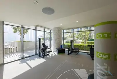 an office with a large glass walled room with desks and chairs at Charming 1BR Apartment at Marina Vista Tower 2 Emaar Beachfront Dubai Marina by Deluxe Holiday Homes in Dubai