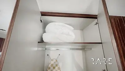 a mirror in a bathroom with a stack of towels at Rare Holiday Homes - Near Madame Tussauds - Goldcrest Executive - R3012 - Jumeirah Lake Towers in Dubai