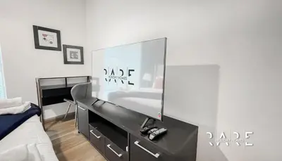 a bedroom with a large mirror on the wall at Rare Holiday Homes - Near Madame Tussauds - Goldcrest Executive - R3012 - Jumeirah Lake Towers in Dubai