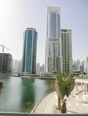 a city with tall buildings and a body of water at Rare Holiday Homes - Near Madame Tussauds - Goldcrest Executive - R3012 - Jumeirah Lake Towers in Dubai