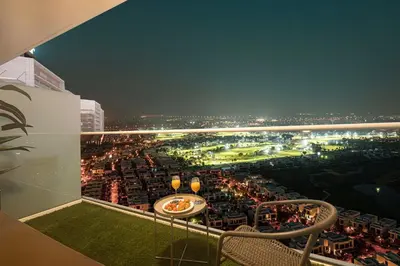 a view of a golf course at night at SmartStay at Carson Tower - Panoramic City Views - Modern Luxury Apartments in Dubai