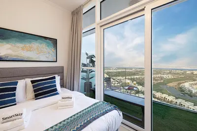 a bedroom with a bed and a large window at SmartStay at Carson Tower - Panoramic City Views - Modern Luxury Apartments in Dubai