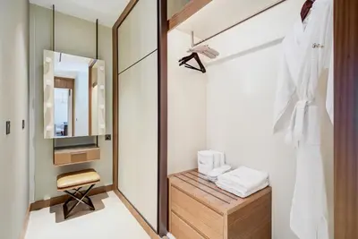a dressing room with a mirror and a dressing table at CitiHome-2BR at Address Opera in the Heart of Downtown in Dubai