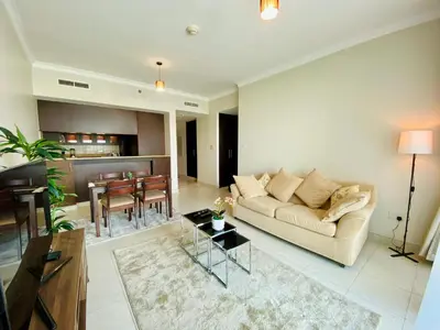 a living room with a couch and a table at Greens in Dubai