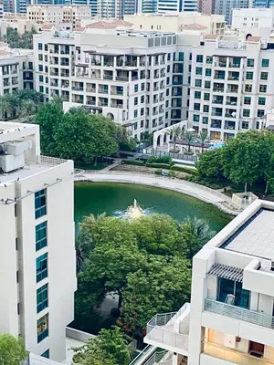 an aerial view of a river in a city with buildings at Greens in Dubai