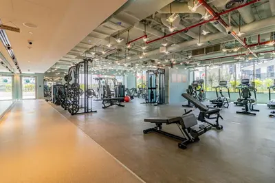 a gym with several treadmills and exercise machines at Elegant MAG 318 Studio Near Dubai Mall in Dubai