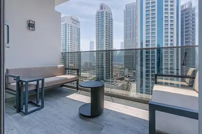 a balcony with a bench and a view of a city at Elegant MAG 318 Studio Near Dubai Mall in Dubai
