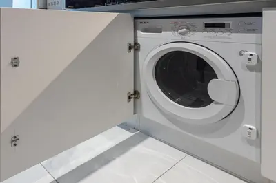a white washing machine in a laundry room at Elegant MAG 318 Studio Near Dubai Mall in Dubai