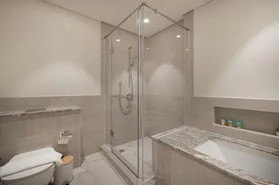 a bathroom with a shower and a toilet and a sink at Lux 3BR With Spectacular Downtown Views in Dubai