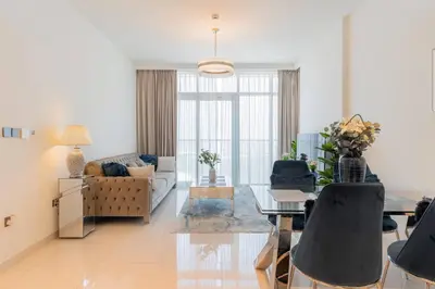 a living room with a couch and a table at Luxury Sunrise Bay 1BR - Panoramic Sea View with Exclusive Amenities, by Think Realty in Dubai