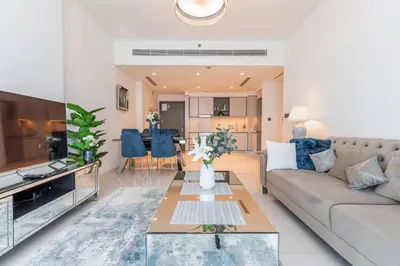 a living room with a couch and a table at Luxury Sunrise Bay 1BR - Panoramic Sea View with Exclusive Amenities, by Think Realty in Dubai