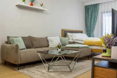 a living room with a couch and a table at Dubai marina - Luxury Studio Apartment in Dubai