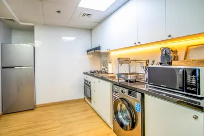 a kitchen with a washer and dryer at Dubai marina - Luxury Studio Apartment in Dubai