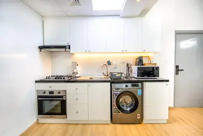 a kitchen with a washing machine and a washer at Dubai marina - Luxury Studio Apartment in Dubai