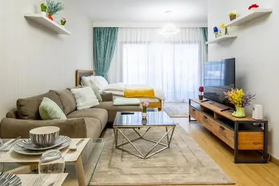 a living room with a couch and a tv at Dubai marina - Luxury Studio Apartment in Dubai