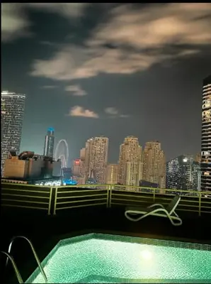a swimming pool with a view of a city at Great Location in Dubai Marina!! in Dubai