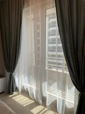 a bedroom with white curtains and a large window at Great Location in Dubai Marina!! in Dubai